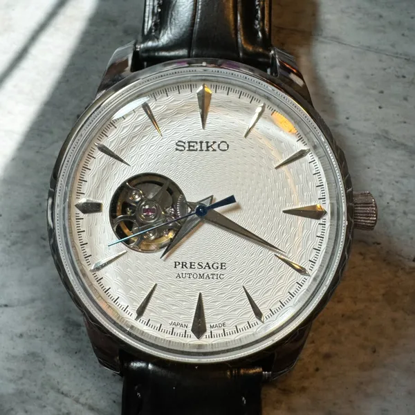 White textured Presage open-heart dial on a black leather strap