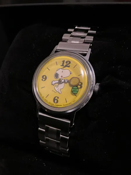 Restored Snoopy tennis watch with a yellow dial and steel bracelet